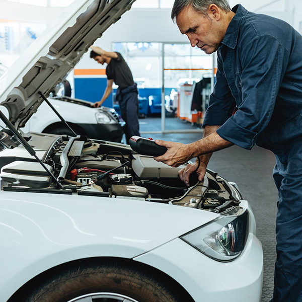 Mechanic reading the error codes with diagnostic device