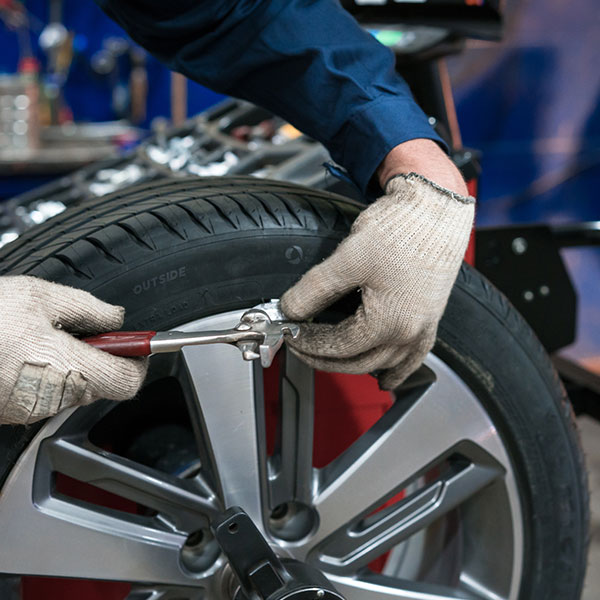 Car mechanic repairing car wheel