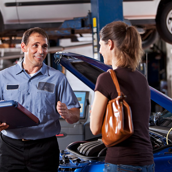Auto mechanic with customer