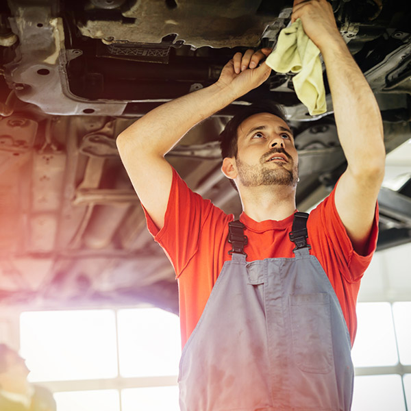 Car mechanics working and maintaining car