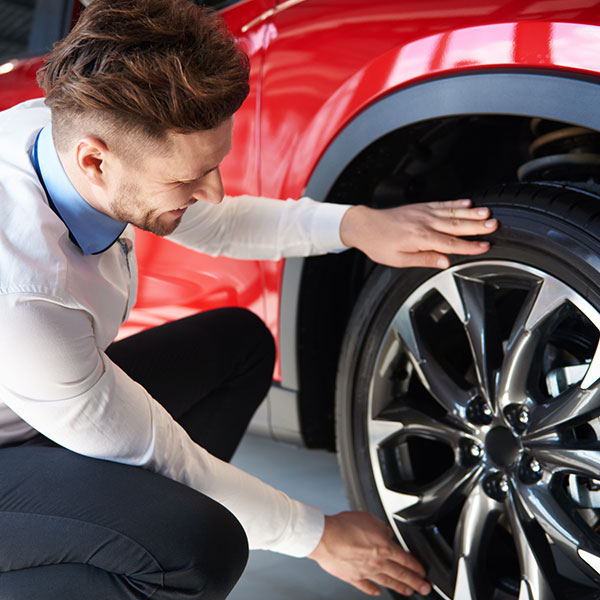 Salesman checking the shiny rims