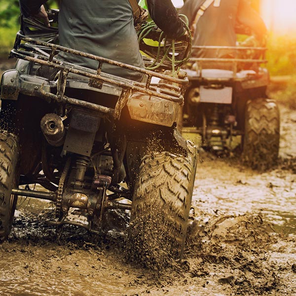 man riding atv vehicle on off road track